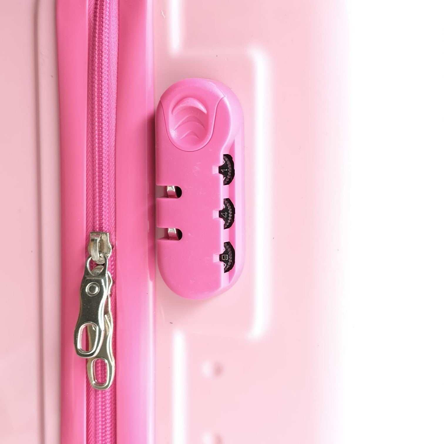 Pink suitcase with a zipper and lock mechanism on a white background